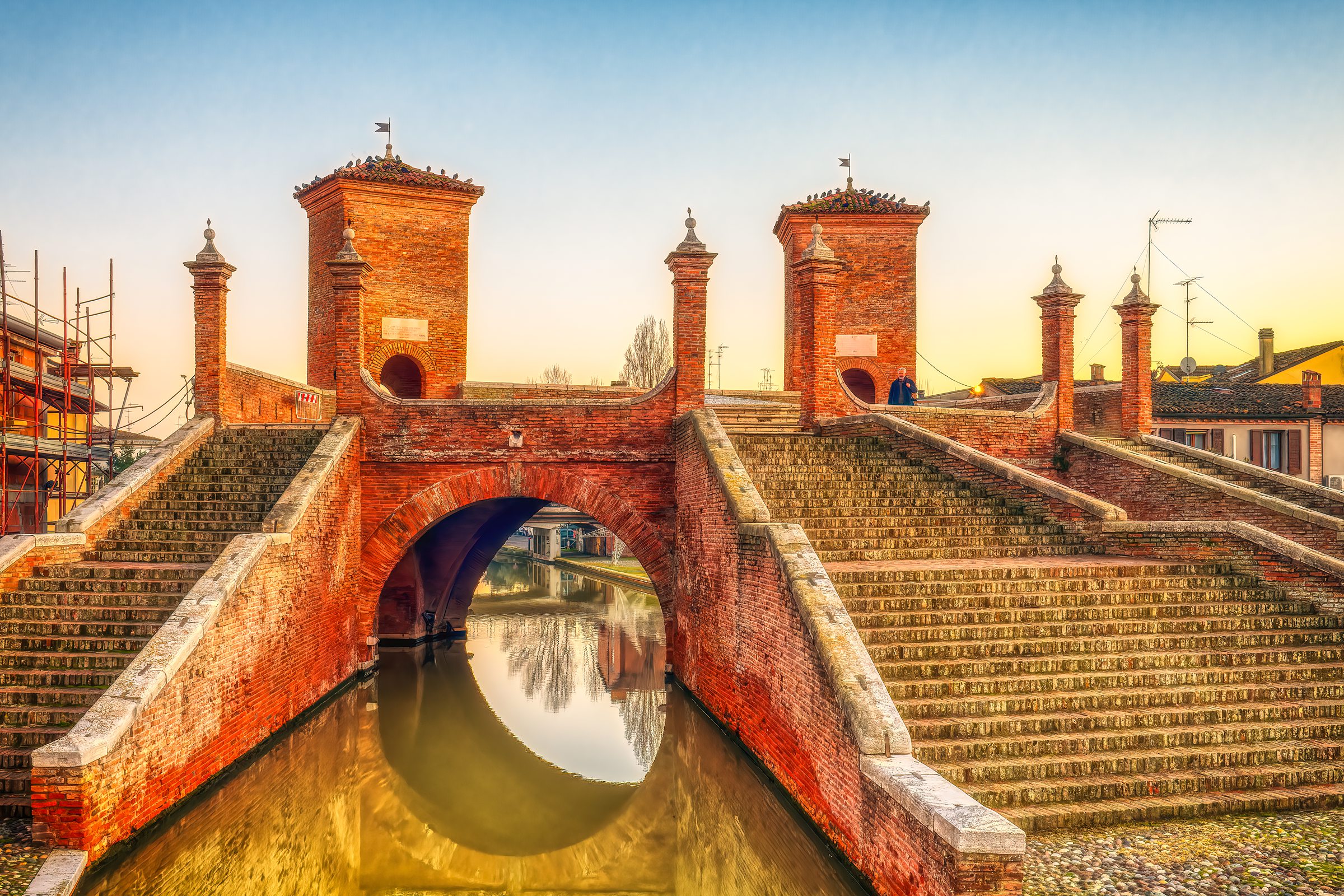 Sunset Magic: Driving Through the Valli di Comacchio Wetlands 8 Historic Trepponti Bridge in Comacchio with five staircases reflected in canal