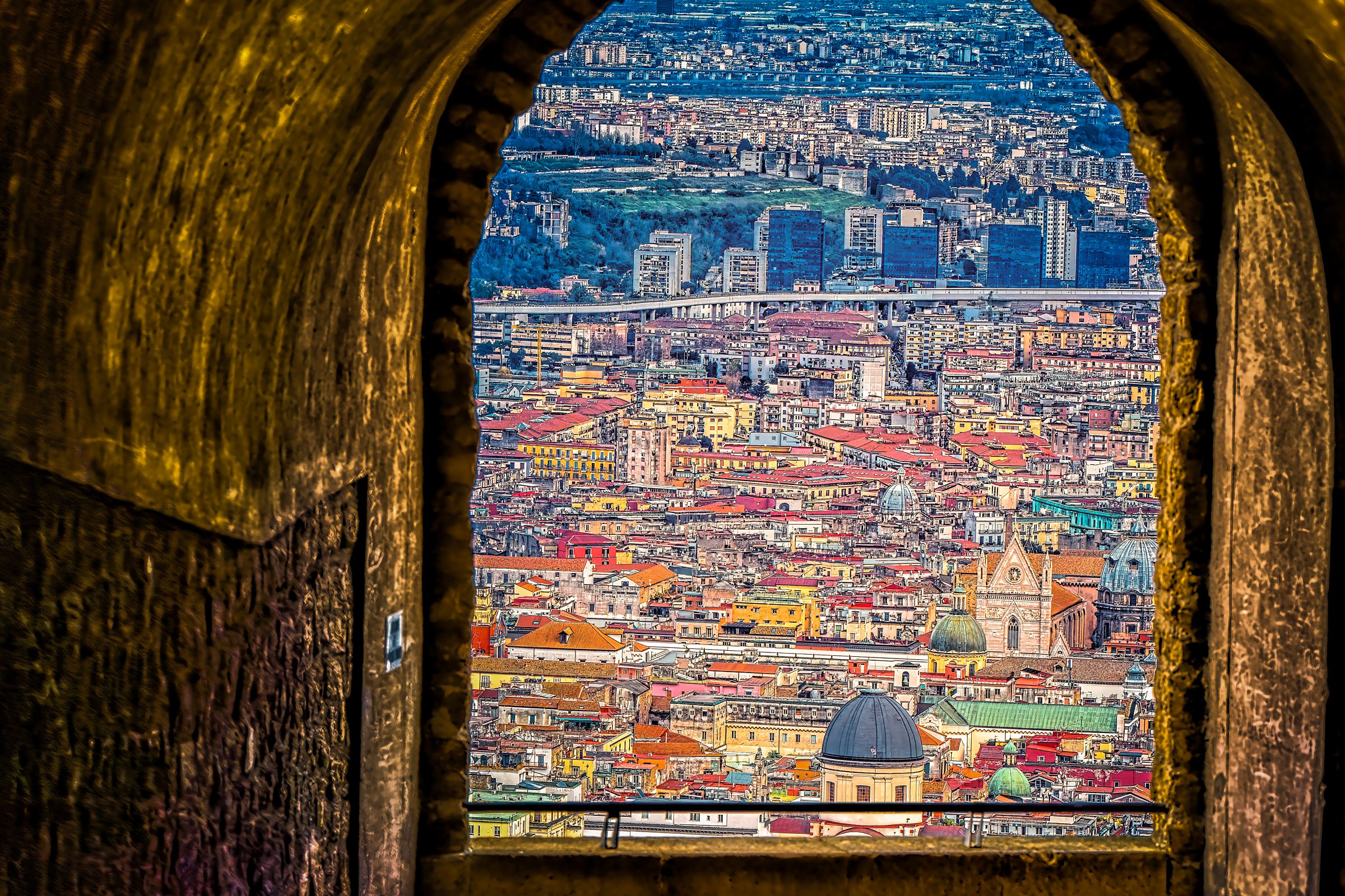Naples through Castel Sant'Elmo window - Cityscape with rooftops and domes framed by ancient stone